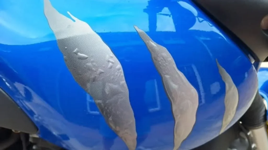 Bubbling paint on a plastic motorcycle fuel tank caused by ethanol in modern petrol