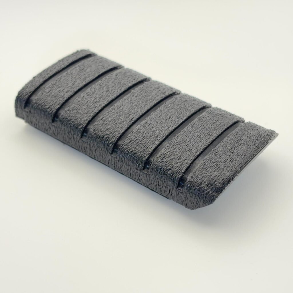 Close-up of the finished Tiger Forge Designs replacement Triumph T2080227 footrest rubber showing the engineered grip texture and production finish.