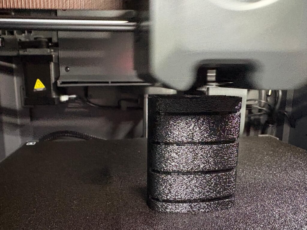 Prototype Triumph T2080227 footrest rubber being printed in Elegoo Rapid TPU 95A on an Elegoo Centauri Carbon 3D printer.