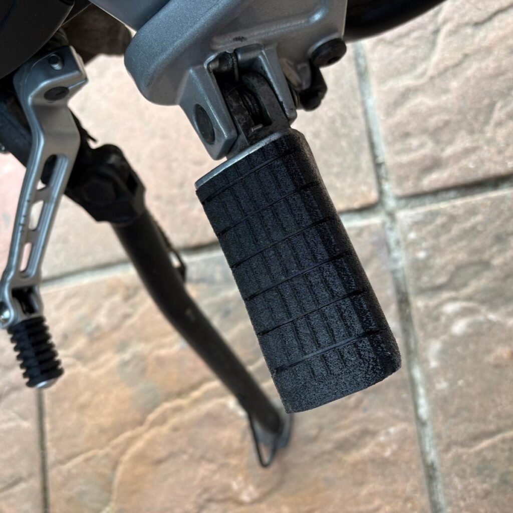 Black TPU Triumph T2080227 replacement footrest rubber fitted to a motorcycle foot peg